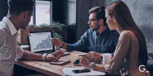 Background picture of a group working at a desk in an office