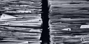 Black and white background image of piles of paper