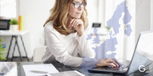Background picture of a woman working at a computer.