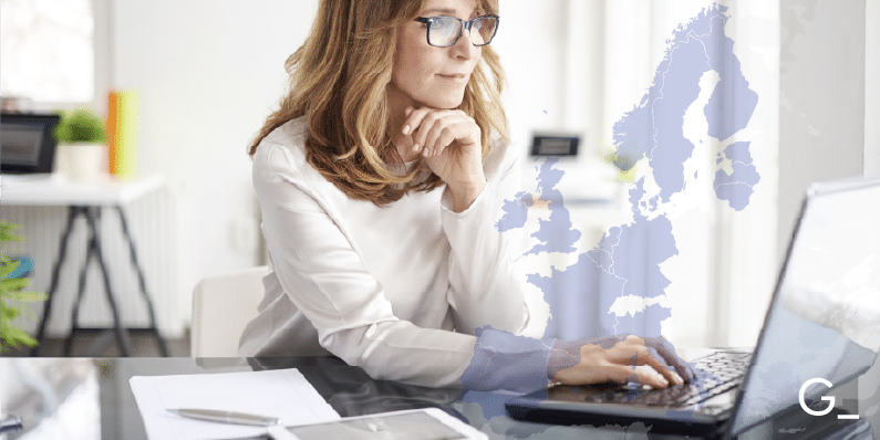Background picture of a woman working at a computer.